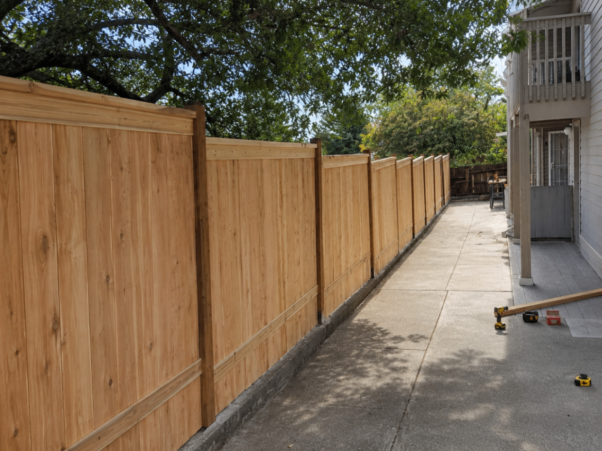 New wood fence installed along a residential walkway